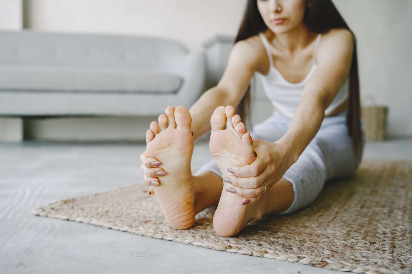 girl-doing-yoga-exercises-home-near-sofa-window-sportswear_1157-46131
